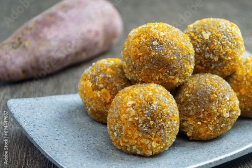 Bola-bola ubi ungu goreng are a snack that is easily found in Indonesia. made from a mixture of steamed purple sweet potato, sugar and tapioca flour that is stirred, shaped into balls and fried. photo