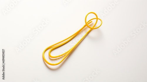 a visually appealing composition of a bright yellow hairpin, emphasizing its delicate details and cheerful color, isolated on a clean white surface.