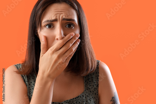 Shocked young woman coverin...