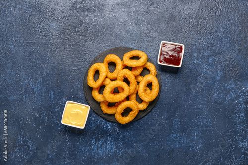 Crispy onion rings on black...
