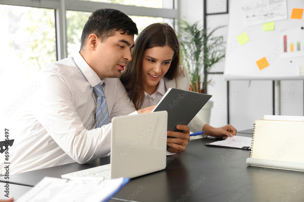 Business people working together at table in office Business people working together at table in office