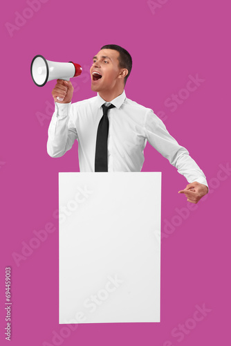 Young man with blank poster...