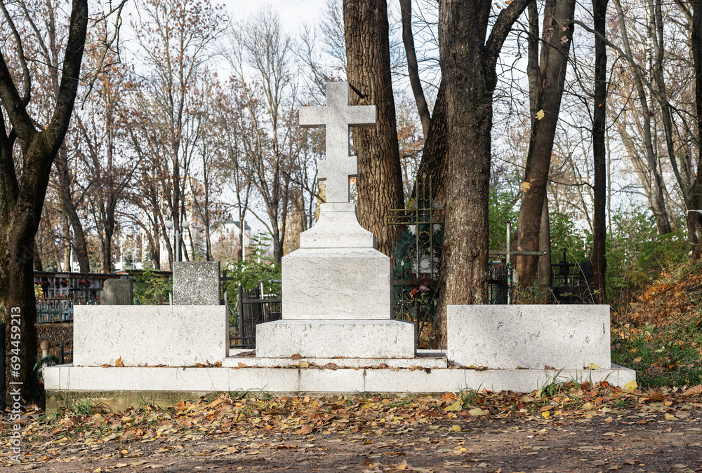 Cross at cemetery. Religious gravestone. Death concept