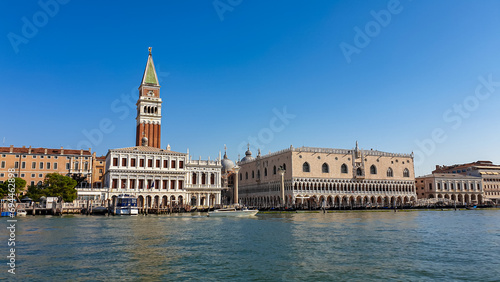 Scenic view of the channel Canala Grande tower of St Mark's Campanile in city of Venice, Veneto, Northern Italy, Europe. Venetian architectural landmarks. Romantic vacation. Speed boat passing by