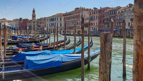 Group of gondolas moored in channel Canal Grande with scenic view of famous Rialto bridge in city of Venice, Veneto, Northern Italy, Europe. Venetian architectural landmarks. Romantic vacation © Chris