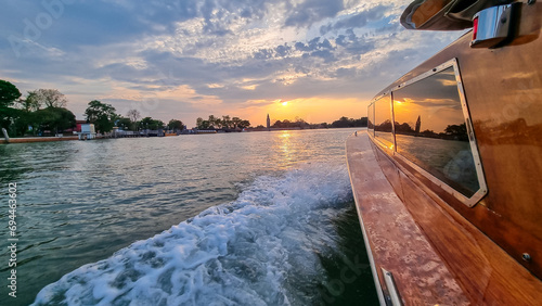 Boat ferry ride with scenic sunset view over Venetian lagoon seen from in Venice photo