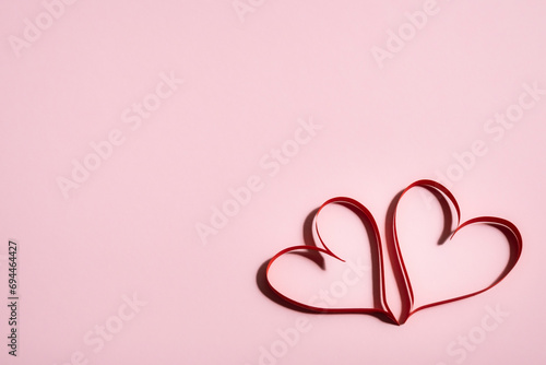 Two beautiful hearts on a pink background, symbol of love, Valentine's Day, happy woman, mother, greeting card design. photo