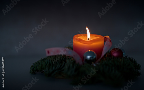Advent candle with fir branches and baubles