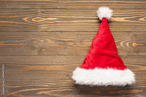 Santa Claus hat on brown wooden background