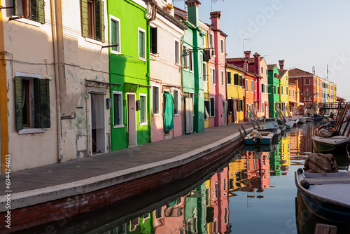Scenic view of bright colorful houses on island of Burano in city of Venice, Veneto, Northern Italy, Europe. Cruising around the Venetian Lagoon. Water canal along idyllic riverbank. Summer tourism © Chris
