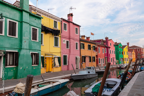 Scenic view of bright colorful houses on island of Burano in city of Venice, Veneto, Northern Italy, Europe. Cruising around the Venetian Lagoon. Water canal along idyllic riverbank. Summer tourism © Chris