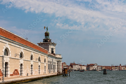 Approaching the Punta della Dogana on the Fondamenta delle Zattere in city of Venice, Veneto, Northern Italy, Europe. Venetian architectural landmarks. Scenic view of channel Canala Grande. Dorsoduro photo