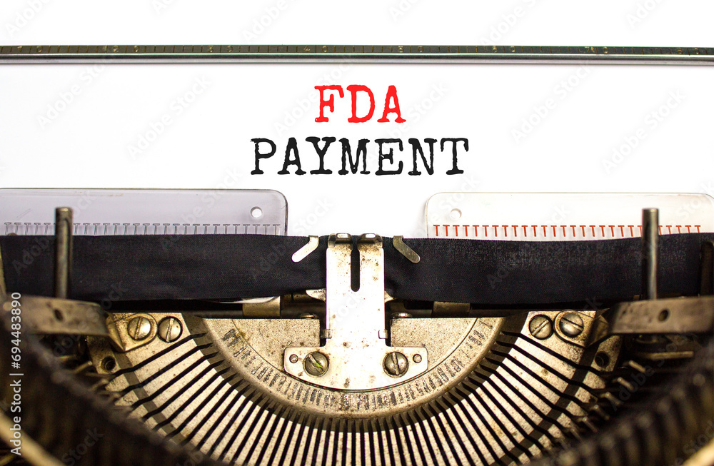 FDA Food and Drug Administration payment symbol. Concept words FDA payment typed on beautiful old retro typewriter. Beautiful white paper background. Business FDA payment concept. Copy space.