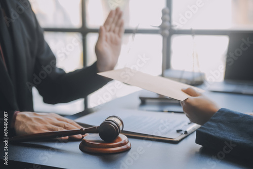 Business and lawyers discussing contract papers with brass scale on desk in office. Law, legal services, advice, justice and law concept picture with film grain effect