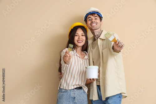 Young couple with paint can...