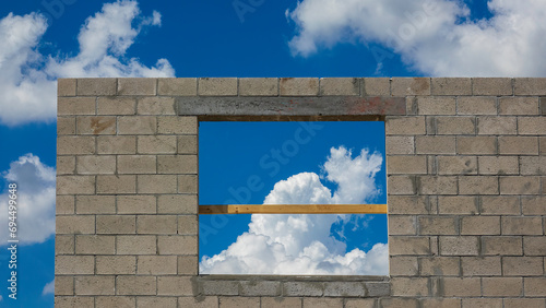 Rectangular window opening in concrete wall of a suburban house under construction on a partly cloudy afternoon in southwest Florida, for concepts of purpose and beginnings