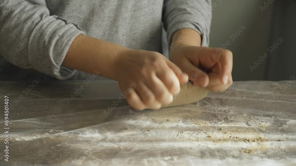 Women's hands knead and beat a clay ball to make ceramic products. Close-up. Creative hobby. Women's hands knead and beat a clay ball to make ceramic products. Close-up. Creative hobby.