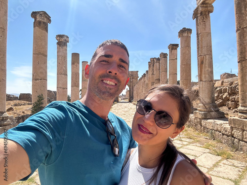 Selfie of a heterosexual couple in the ruins of a historical city. Young boy and girl taking a selfie between the columns of the Jerash reserve, Jordan.