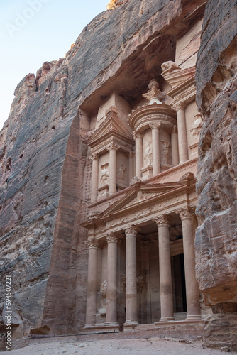 Solitary visit to the Treasury of Petra, Jordan. Side view of the façade and the ruins of the ancient city carved in stone.s