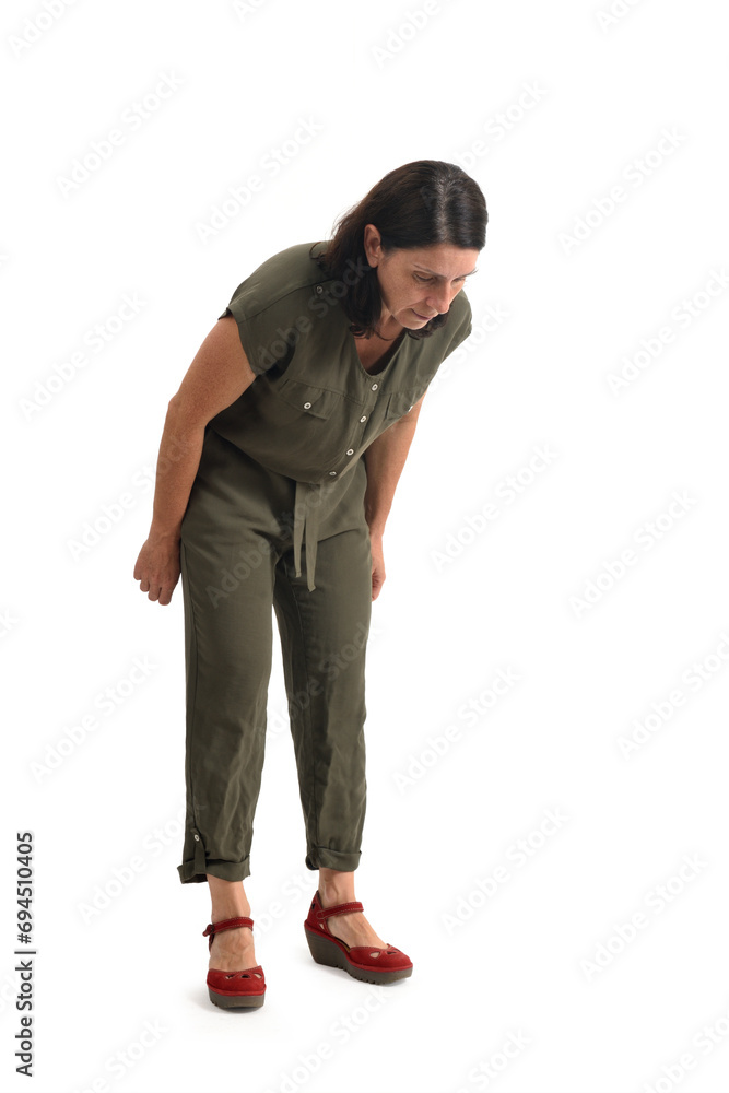 view of a woman standing looking at the floor searching for something on white background. view of a woman standing looking at the floor searching for something on white background.