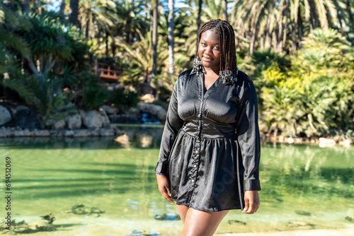 Portrait of young body positive african woman outdoors