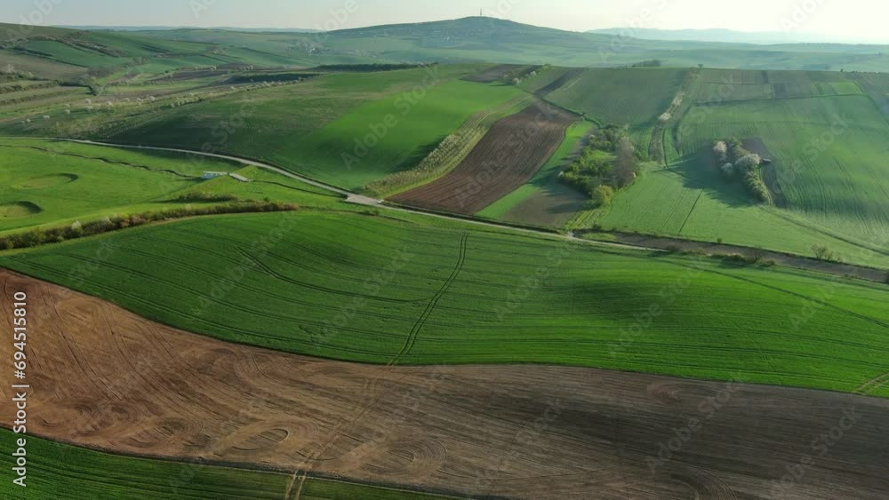 Aerial view of amazing green wavy hills with agricultural fields in spring. South Moravia region, Czech Republic, Europe, 4k Aerial view of amazing green wavy hills with agricultural fields in spring. South Moravia region, Czech Republic, Europe, 4k