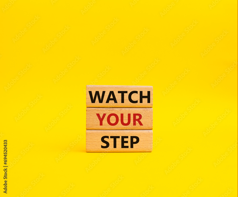 Watch your Step symbol. Concept words Watch your Step on wooden blocks. Beautiful yellow background. Business and Watch your Step concept. Copy space. Watch your Step symbol. Concept words Watch your Step on wooden blocks. Beautiful yellow background. Business and Watch your Step concept. Copy space.