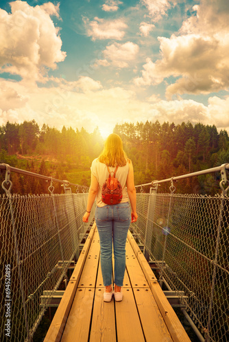 Young woman on a suspension bridge
