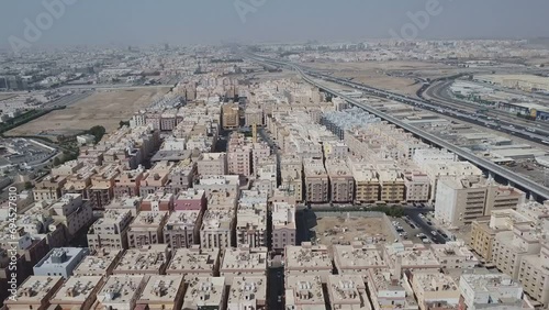 Bird's Eye View of a couple of Saudi Arabia's Many Multi Lane Highways next to a peaceful Residential Neighborhood with a Mosque in the middle