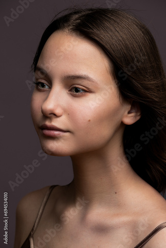 Studio beauty closeup portrait of teen inspiring smiling beautiful girl.