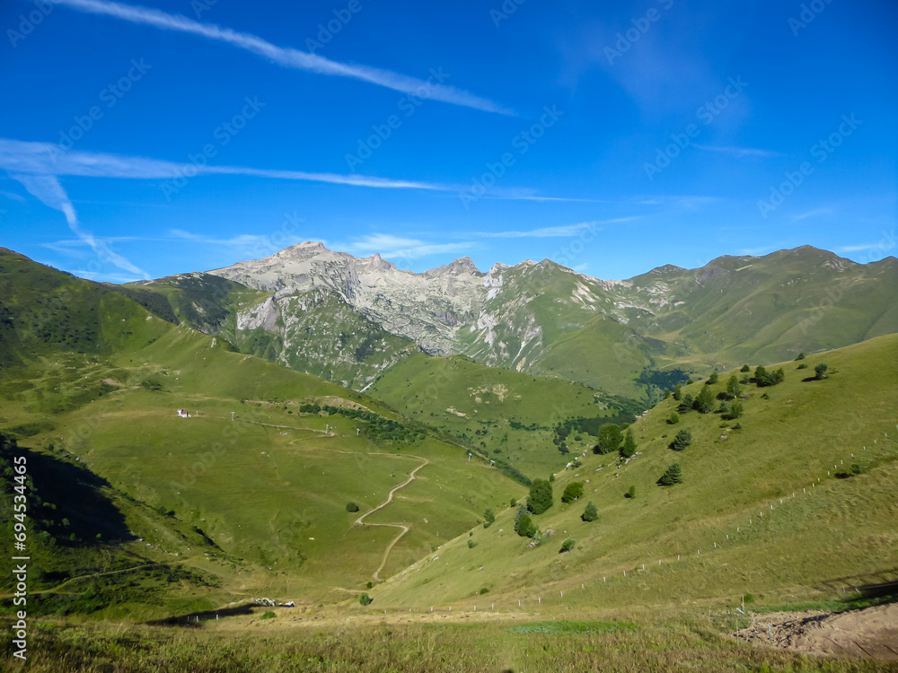Scenic mtb trail along ancient pathway from the Alps to the sea, through the Italian regions of Piemonte and Liguria, and France. Looking at endless mountain ranges and lush green pastures and hills.