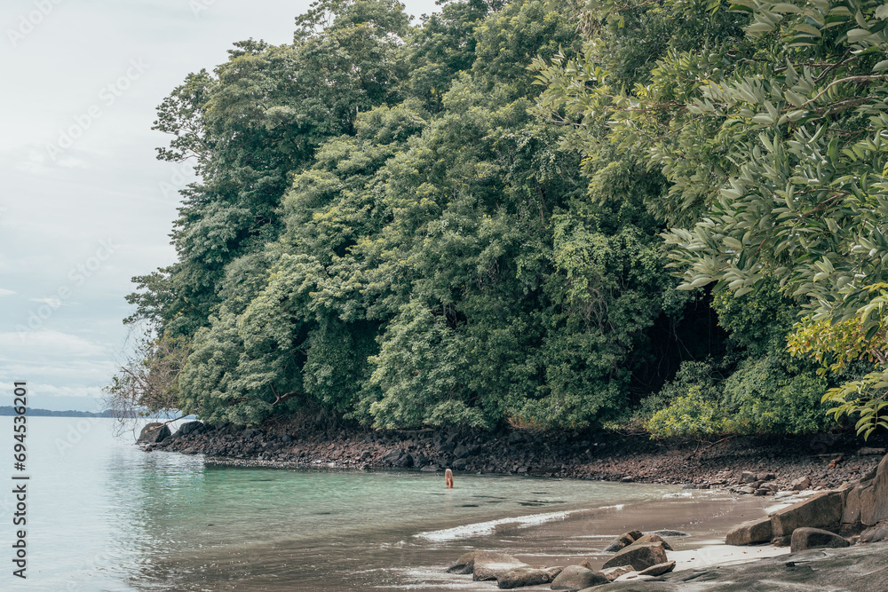 Blonde woman inside turquoise sea. Wild tropical beach. Travel vacation Panama