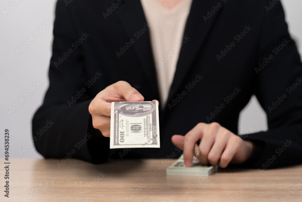 Business hands counting US Dollar bills or paying in cash ,Businessman giving or paying money ,copy space. Business hands counting US Dollar bills or paying in cash ,Businessman giving or paying money ,copy space.