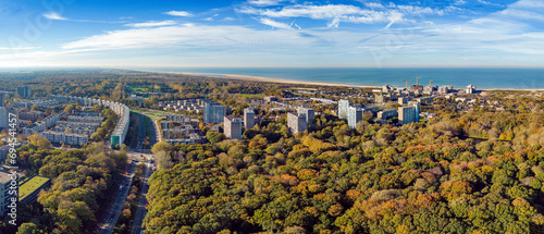 Aerial panorama photo of the seaside resort Kijkduin with the adjacent neighborhoods and the Meer en Bos park in the foreground in November 2022.