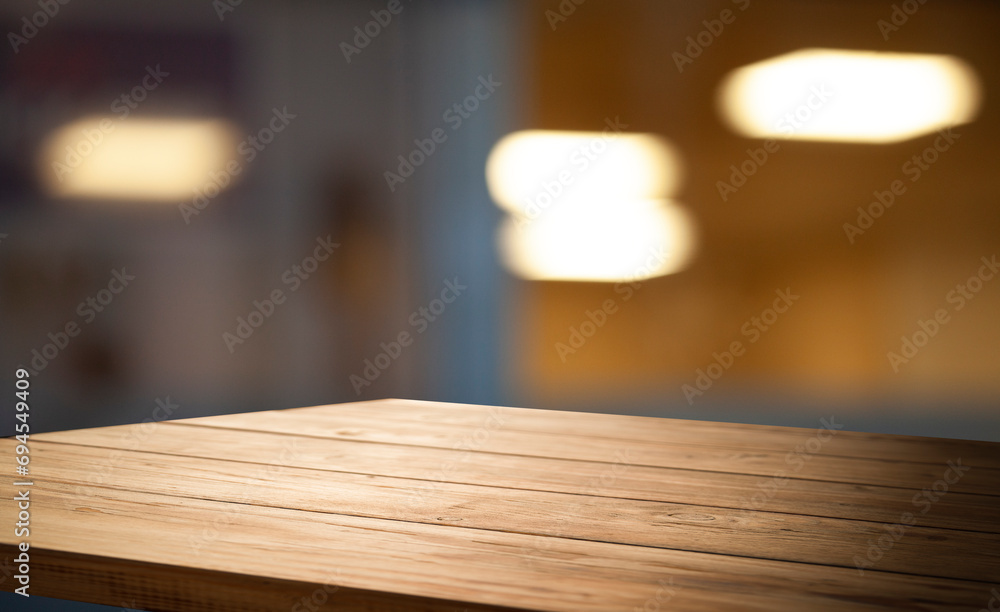 Empty wooden table top on blur light golden bokeh of cafe restaurant, bar in a dark background. Empty wooden table top on blur light golden bokeh of cafe restaurant, bar in a dark background.
