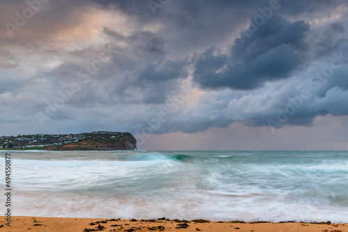 Wet weather sunrise with choppy waves at the seaside