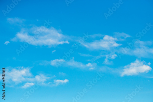Blue sky with white soft puffy clouds