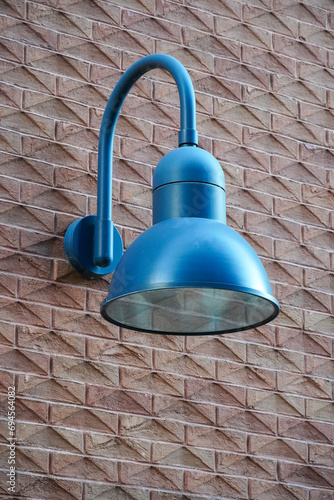 Close up of blue color lantern on red brick textured wall, Roterman city district, Tallinn, Estonia, Europe photo