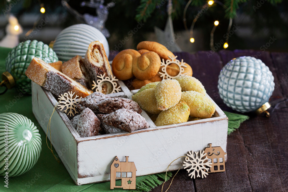 Assorted Christmas cookies with different fillings, Christmas decorations on a wooden background. Rustic style.