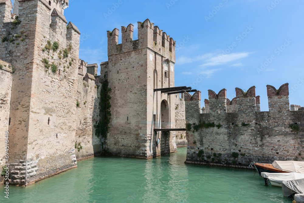 Green water of moat around medieval Italian castle
