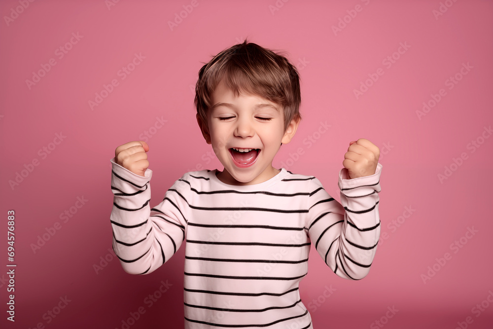 A young boy Celebrating a special occasion birthday, with joy and happiness in a studio setting with colorama backdrop A young boy Celebrating a special occasion birthday, with joy and happiness in a studio setting with colorama backdrop