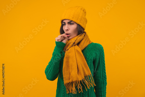 Portrait of young sad woman feeling unwell, isolated over yellow background