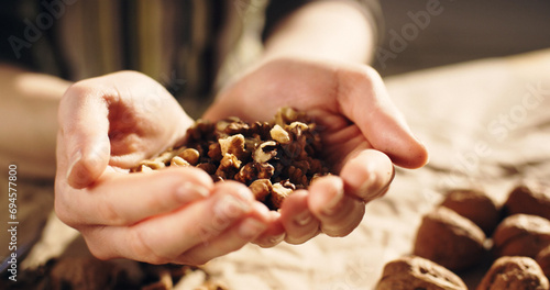 Close-up shot of a woman holding a handful of walnuts. photo