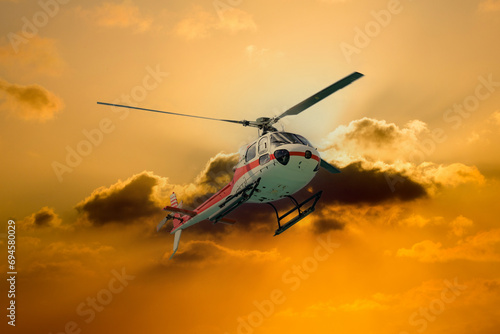 Fototapeta Naklejka Na Ścianę i Meble -  Hubschrauber im Flug beim Sonnenuntergang