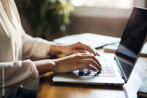 A writer deeply engrossed in typing a novel on a laptop, her fingers moving swiftly