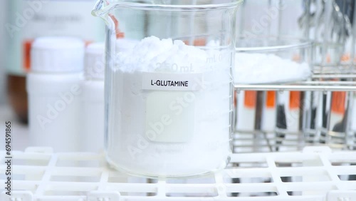 L-GLUTAMINE powder in chemical container , chemical in the laboratory and industry, Raw materials used in production or analysis photo