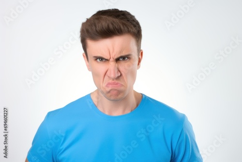 Disgruntled Young Man in Blue Shirt with a Scowl. Generative AI.