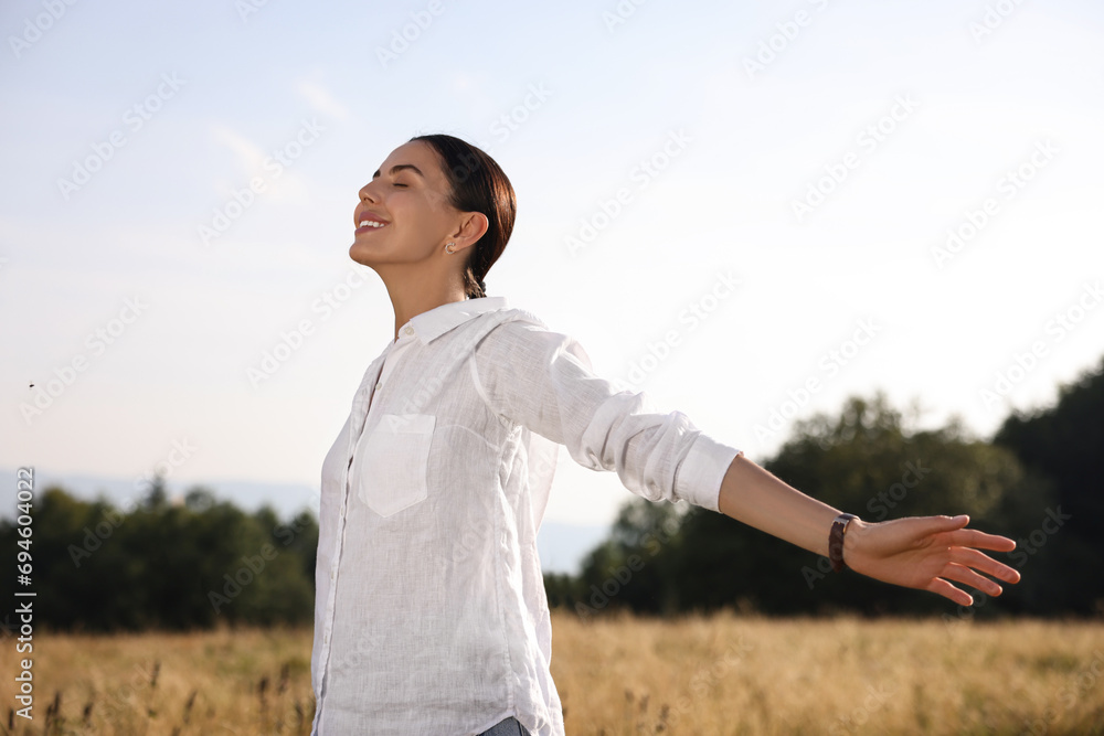 Feeling freedom. Happy woman with wide open arms outdoors Feeling freedom. Happy woman with wide open arms outdoors