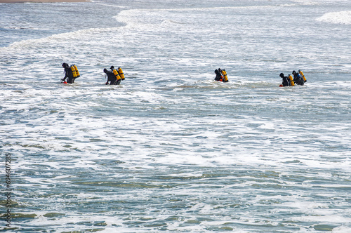Tactical divers, frogmen, enter the sea from a beach in Mar del Plata, Argentina photo