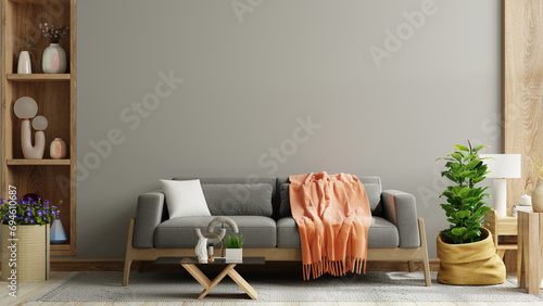 Cozy living room with grey sofa on dark wall and wooden flooring